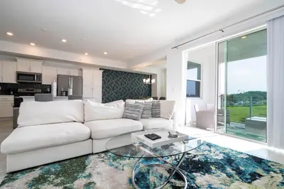 a living room with a white couch and a glass table at 3191 Unit 207 Stunning apartment in Kissimmee