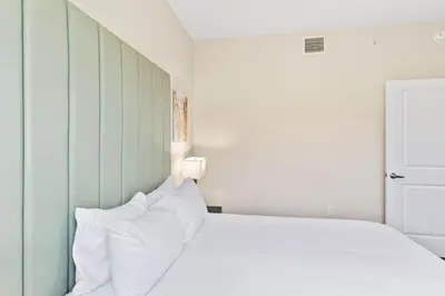 a bedroom with a bed with white pillows at 4012 Breakview Drive 210 in Orlando