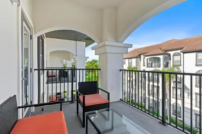 a balcony with a chair and a table at 4012 Breakview Drive 410 in Orlando