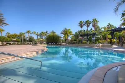 a swimming pool at a resort with palm trees at 4012 Breakview Drive 410 in Orlando