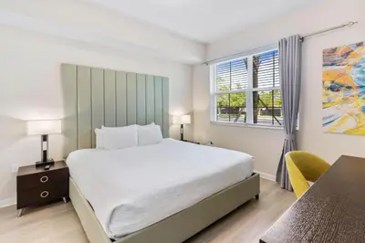 a bedroom with a bed and a desk and a window at 4013 Breakview Drive 108 in Orlando