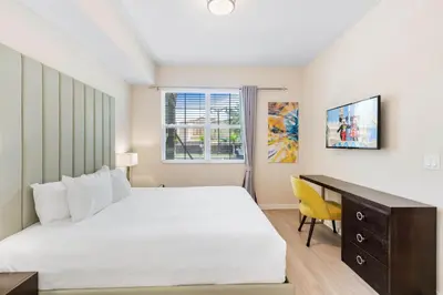 a bedroom with a bed and a desk and a window at 4013 Breakview Drive 108 in Orlando