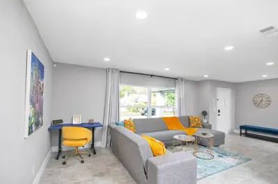 a living room with a couch and a table at Home away from home in Orlando! in Orlando