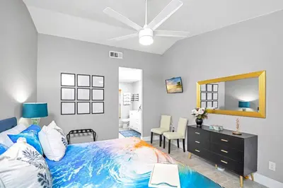 a bedroom with a bed and a dresser and a mirror at Home away from home in Orlando! in Orlando