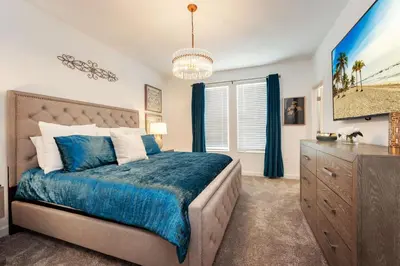 a bedroom with a blue bed and a dresser at New Beautiful 7 br w pool games theme rooms in Kissimmee