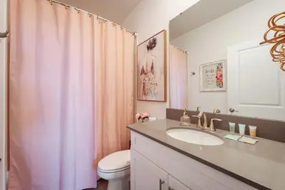 a bathroom with a sink and a toilet and a shower at New Beautiful 7 br w pool games theme rooms in Kissimmee