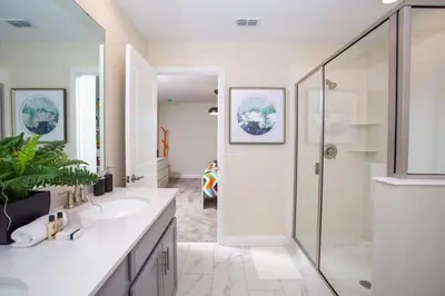 a bathroom with two sinks and a shower at 4577 Stunning 7 bedroom home in Kissimmee