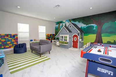 a living room with a house painted on the wall at 4577 Stunning 7 bedroom home in Kissimmee