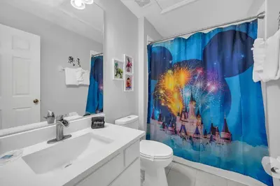 a bathroom with a toilet and a shower curtain at Townhome near Disney with pool Magic and Fun at Windsor in Orlando