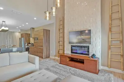 a living room with a couch and a tv at Beautiful 4 suites - Close to Disney 7505 in Orlando