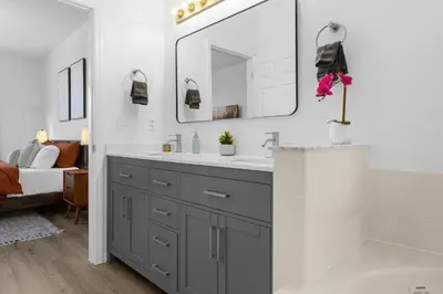 a bathroom with a sink and a mirror at Lake View Vacation Home with Pool and Game Room Near Disney Parks in Kissimmee