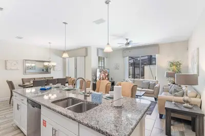 a kitchen and living room with a counter and a living room at 4813 Crusoe Street in Kissimmee