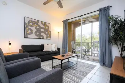 a living room with a couch and a table at Dream Cozy 3BR Condo - Disney 5 Min Walk to Pool in Orlando
