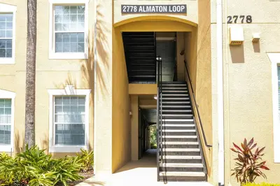 a building with a staircase in front of it at Dream Cozy 3BR Condo - Disney 5 Min Walk to Pool in Orlando
