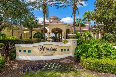 a house with a sign in front of it at Dream Cozy 3BR Condo - Disney 5 Min Walk to Pool in Orlando