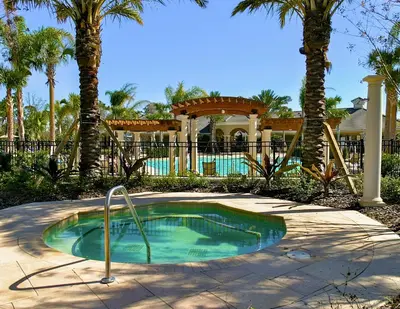 a small swimming pool in a yard with palm trees at Dream Cozy 3BR Condo - Disney 5 Min Walk to Pool in Orlando