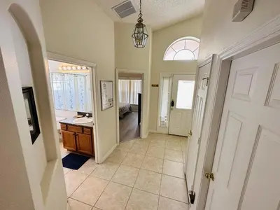 a hallway of a home with a sink and a door at Spacious, Open Layout And Pool Relaxation! in Orlando