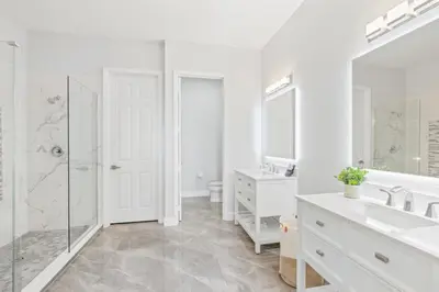 a white bathroom with two sinks and a shower at Luxury Lakeview Penthouse, Vista Cay Orlando 1025 in Orlando