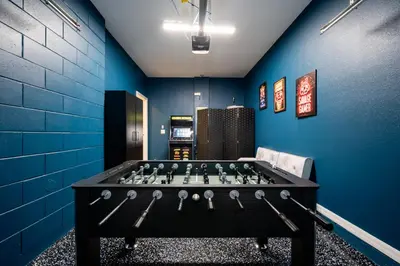 a room with a foosball table in the middle at Compass Point Villa S in Kissimmee