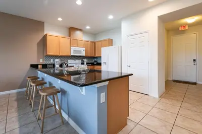 a kitchen with a large island with a counter top at Compass Point Villa S in Kissimmee