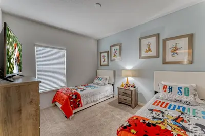 a bedroom with two beds and a flat screen tv at Happy Holiday Hideaway G in Kissimmee