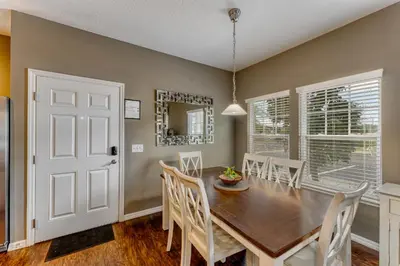 a dining room with a wooden table and chairs at Happy Holiday Hideaway G in Kissimmee