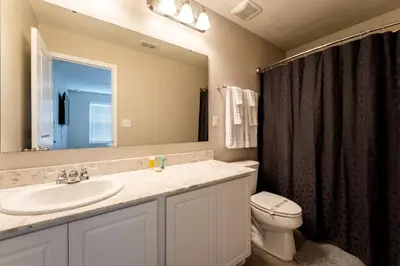 a bathroom with a sink and a toilet and a mirror at Making Memories G in Kissimmee