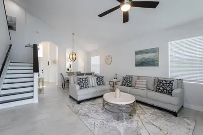 a living room with couches and a ceiling fan at Lakeview Villa G in Orlando