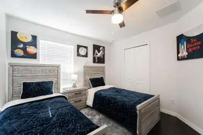 a bedroom with two beds and a window at Lakeview Villa G in Orlando