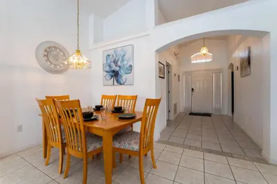 a dining room with a wooden table and chairs at Eagle's End S in Kissimmee