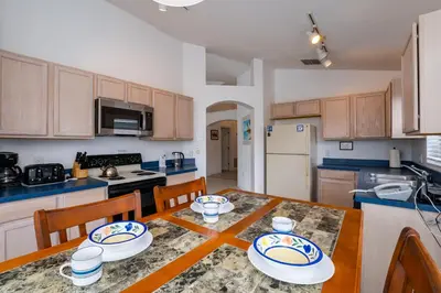 a kitchen with a table and chairs and a kitchen with a table and a kitchen at Eagle's End S in Kissimmee