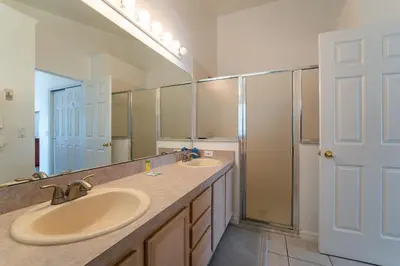 a bathroom with two sinks and a large mirror at Eagle's End S in Kissimmee