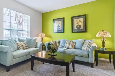 a living room with two couches and a table at 6 bedrooms pool home Gated resort Veranda Palms in Kissimmee