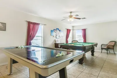 a living room with two pool tables at 6 bedrooms pool home Gated resort Veranda Palms in Kissimmee