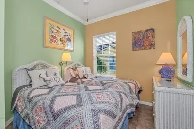 a bedroom with two beds and a window at 3 bedrooms townhome Gated Resort 5 minutes from Disney in Orlando