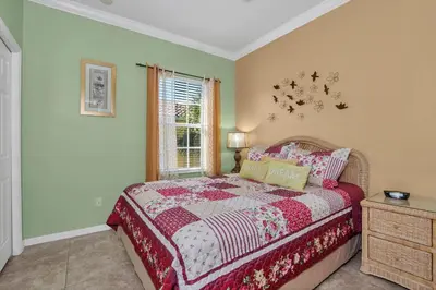 a bedroom with a bed and a window at 3 bedrooms townhome Gated Resort 5 minutes from Disney in Orlando