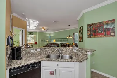 a kitchen with a sink and green walls at 3 bedrooms townhome Gated Resort 5 minutes from Disney in Orlando