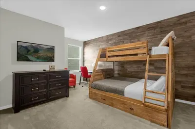 a bedroom with a bunk bed and a desk at 4732TH Cozy home in Kissimmee in Kissimmee