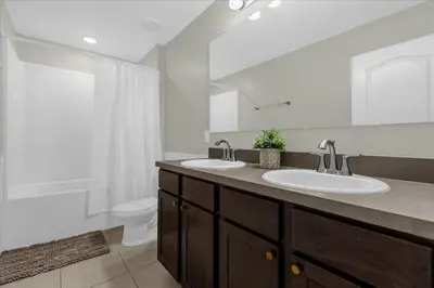 a bathroom with two sinks and a toilet at 4732TH Cozy home in Kissimmee in Kissimmee
