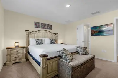 a bedroom with a large bed and a couch at 3BD townhome near Disney 4730 in Kissimmee