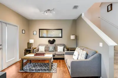 a living room with a couch and a table at Disney Dream Resort Amenities Pool *4BD/3BA* Close to Parks in Kissimmee
