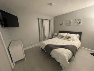 a bedroom with a large bed and a television at Family-Friendly DIsney Getaway in Kissimmee
