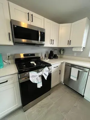 a kitchen with a stove and a microwave at Family-Friendly DIsney Getaway in Kissimmee