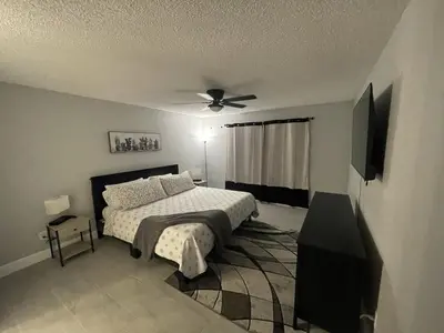 a bedroom with a bed and a ceiling fan at Family-Friendly DIsney Getaway in Kissimmee