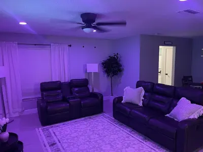 a purple living room with couches and a ceiling fan at Family-Friendly DIsney Getaway in Kissimmee