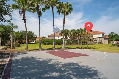a basketball hoop with a red object in a park at Pool Townhouse near to Disney - Bella Vida Resort in Kissimmee