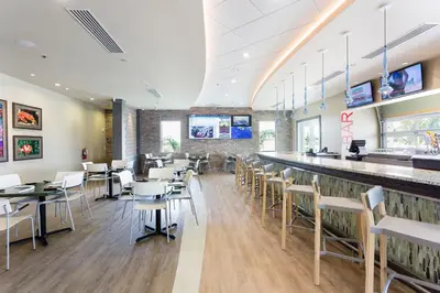 a restaurant with a bar and tables and chairs at Modern 5 BDR Family Themed Home with Harry Potter Games Room and Free Pool Heat in Orlando