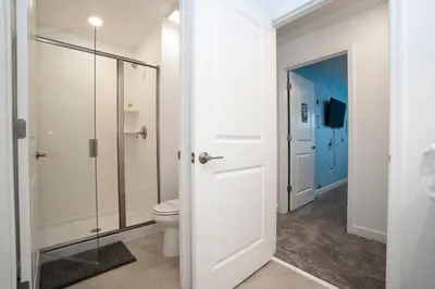 a bathroom with a toilet and a glass shower at Gorgeous 4 Bedroom w Screened Pool Close to Disney 2653 in Kissimmee