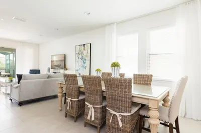 a dining room with a table and chairs and a couch at Fantabulous Disney Vacation House in Orlando