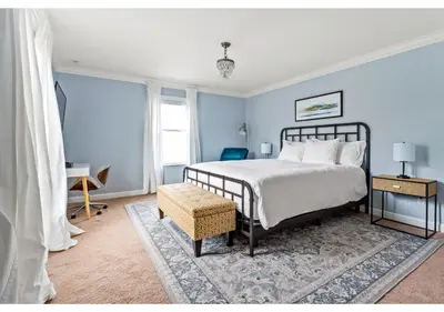 a bedroom with blue walls and a bed and a table at Lakefront 5BR Resort Pool Home Near Disney World in Kissimmee